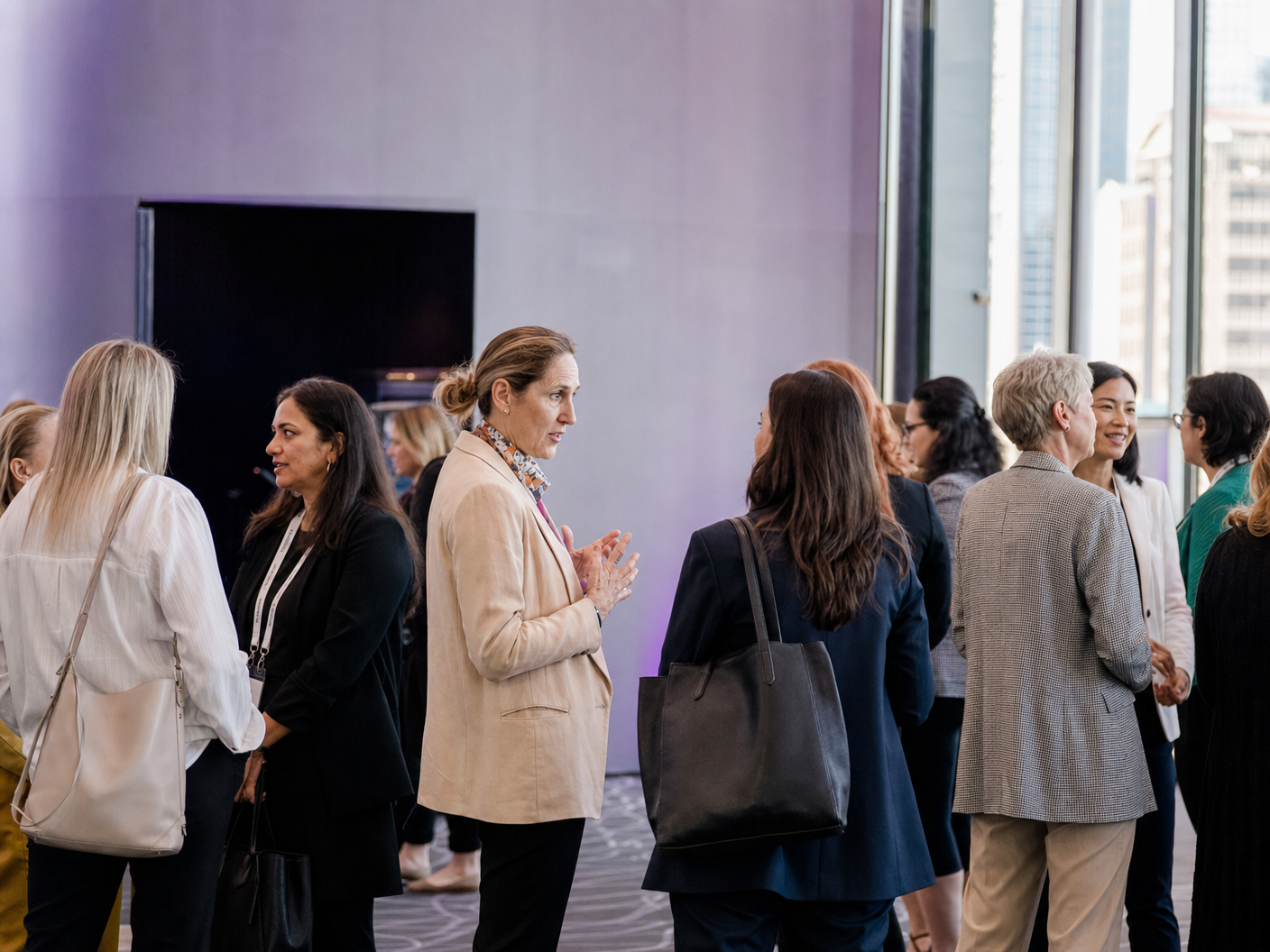 Women speaking in small groups at a professional conference